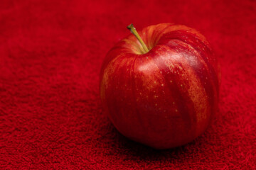 Red apples isolated in red background