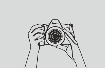 The photographer is holding a camera and is preparing to take a photo. Black vector hands contour on a gray background.