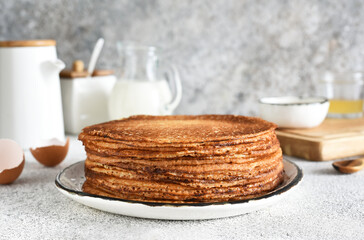 Stack of pancakes on the breakfast plate on a light background. Pancakes in the morning for breakfast.
