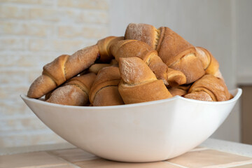 Homemade bagels in a white dish, selective focus.