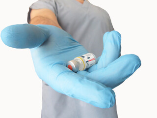 Covid19 vaccine in blue gloved doctor's hand.