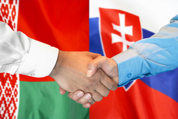 Business handshake on the background of two flags. Men handshake on the background of the Belarus and Slovakia flag. Support concept