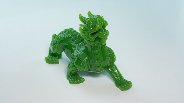 Pixiu or Pi Yao made from jade. Auspicious stuffed animal for worship and blessing for good fortune, wealth and prosperity in commerce. According to Chinese beliefs A doll placed on a white background