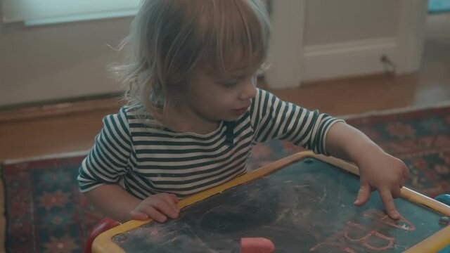child with a chaulk board table