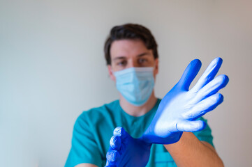 nurse wearing gloves to work in the hospital