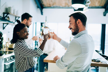 Fototapeta premium Man and African American woman toasting glasses