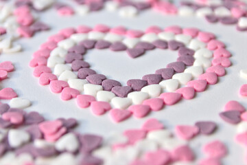 Delicious pink Valentine's Day sugar hearts and ornaments in pink, purple and white show I love you to your girlfriend and beloved people with precious diamonds and red hearts jewelry as special gift