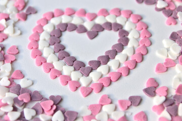 Delicious pink Valentine's Day sugar hearts and ornaments in pink, purple and white show I love you to your girlfriend and beloved people with precious diamonds and red hearts jewelry as special gift