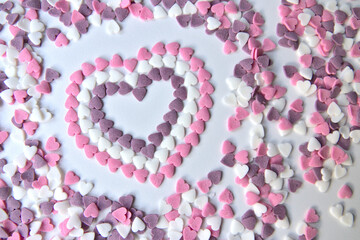Delicious pink Valentine's Day sugar hearts and ornaments in pink, purple and white show I love you to your girlfriend and beloved people with precious diamonds and red hearts jewelry as special gift