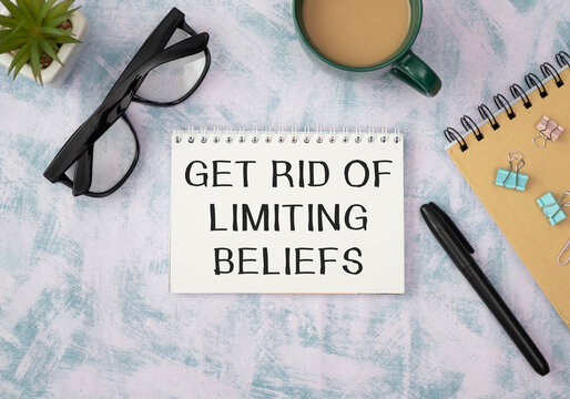 Get Rid Of Limiting Beliefs text on the book isolated on office desk background