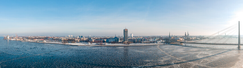 Fototapeta na wymiar Aerial Panorama view of the Vansu bridge and Old Riga over Daugava river in Winter