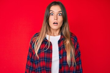 Fototapeta premium Beautiful caucasian woman wearing casual clothes scared and amazed with open mouth for surprise, disbelief face