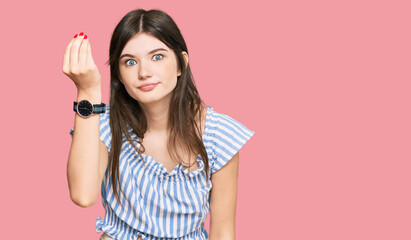 Young beautiful caucasian girl wearing casual clothes doing italian gesture with hand and fingers confident expression