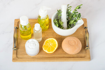 spa lemon face cream and lemon oil, soap and cream on white table