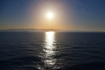 Summer cruise vacation concept. Panoramic view of the sea with a beautiful sunset just above the horizont.
