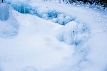 Fototapeta na wymiar Icicles formed around frozen geyser.Winter image.High quality photo