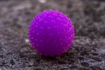Purple anti stress ball, in the hand of a child playing