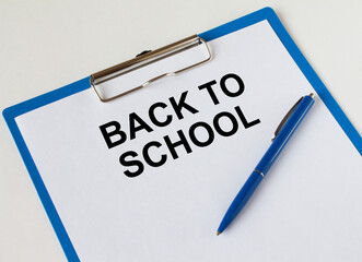 Clipboard with text Back To School and blue pen