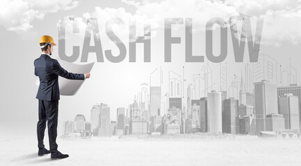 Young businessman with hard hat and CASH FLOW inscription, new business opportunity concept