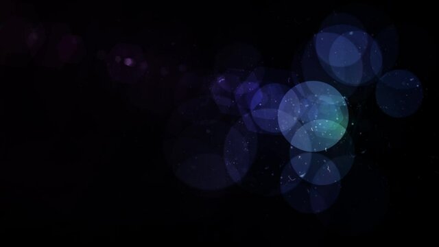 Abstract creative bokeh background. Colorful glowing glitter design, shiny lights on black screen.