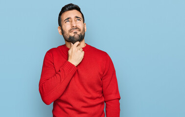 Young hispanic man wearing casual clothes touching painful neck, sore throat for flu, clod and infection