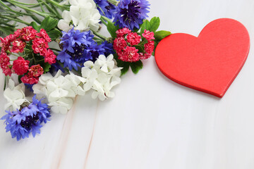 happy valentine's day card. spring flowers on white background and red heart