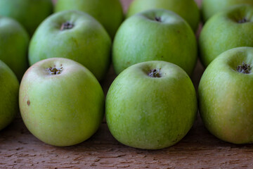 Apples stand on a wooden surface