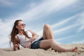 girl on the beach against the blue sky