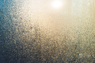 Misted window with drops of moisture that glows in the sun