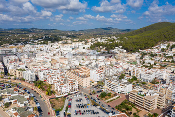 Fototapeta na wymiar Aerial photo of the beautiful island of Ibiza in Spain showing the town centre and hotels on a bright sunny summers day with the mountains in the background