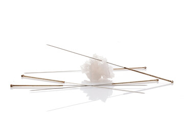 Silver needles for traditional Chinese acupuncture medicine. White background. There is some free space for your text or sign.