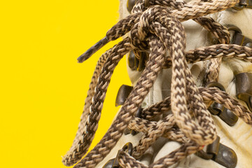 Light lace close-up on a yellow background. The concept of sports. Footwear