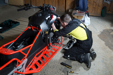 Repair and maintenance of snowmobiles. Maintenance of motor vehicles.
