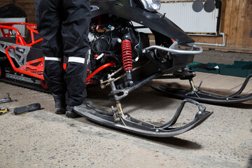 Fototapeta na wymiar Repair and maintenance of snowmobiles. Maintenance of motor vehicles.
