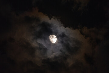 Naklejka na ściany i meble The moon among the stars and clouds