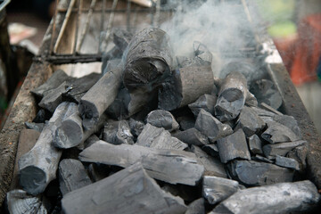 Close up of brightly burning wooden logs with yellow hot flames of fire..