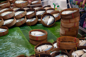 Steamed mackerel in bamboo baskets for sale at the fresh market..