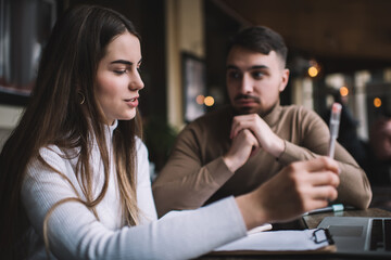 Man looking at female colleague while working on project together