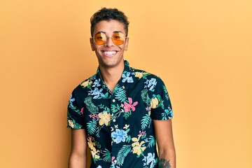 Young handsome african american man wearing summer style with a happy and cool smile on face. lucky...