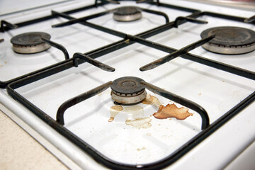 Dirty gas stove burners in kitchen room after cooking