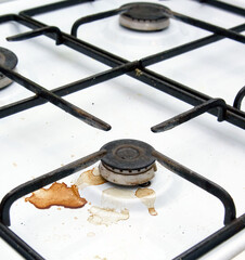 Dirty gas stove burners in kitchen room after cooking