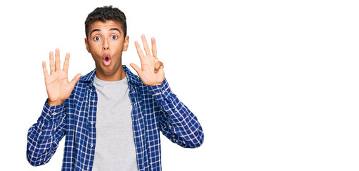 Young handsome african american man wearing casual clothes showing and pointing up with fingers...