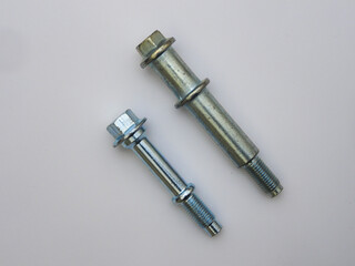 Metal, car bolts, different sizes on a white insulated background. Fasteners, accessories, hardware close-up.