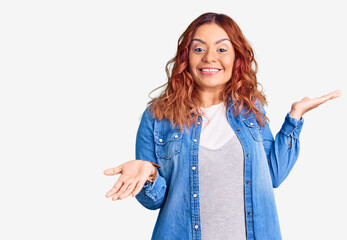 Young latin woman wearing casual clothes clueless and confused expression with arms and hands raised. doubt concept.