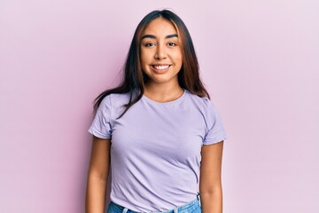 Young latin woman wearing casual clothes with a happy and cool smile on face. lucky person.