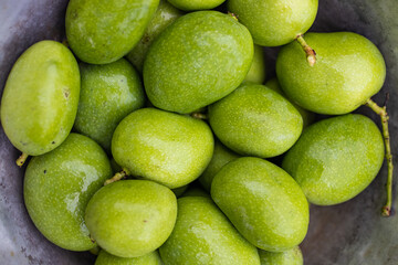 A group of fresh small green mango locally available in the south of Thailand and commonly used in...