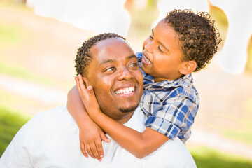 Happy African American Father and Mixed Race Son Playing At The Park