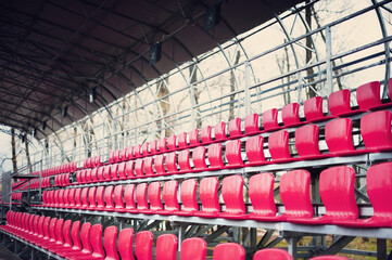 Fototapeta premium Closeup of red seats in the small stadium.