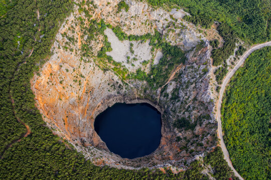 Red Lake (Croatian: Crveno jezero) is a collapse doline (collapse sinkhole) containing a karst lake close to Imotski, Croatia. It is 530 metres deep, thus it is the largest collapse doline in Europe. 