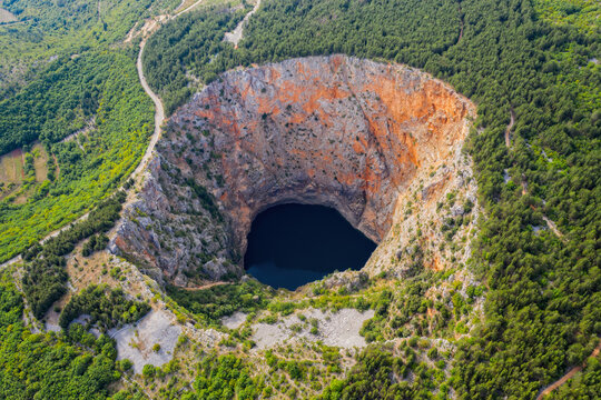 Red Lake (Croatian: Crveno jezero) is a collapse doline (collapse sinkhole) containing a karst lake close to Imotski, Croatia. It is 530 metres deep, thus it is the largest collapse doline in Europe. 